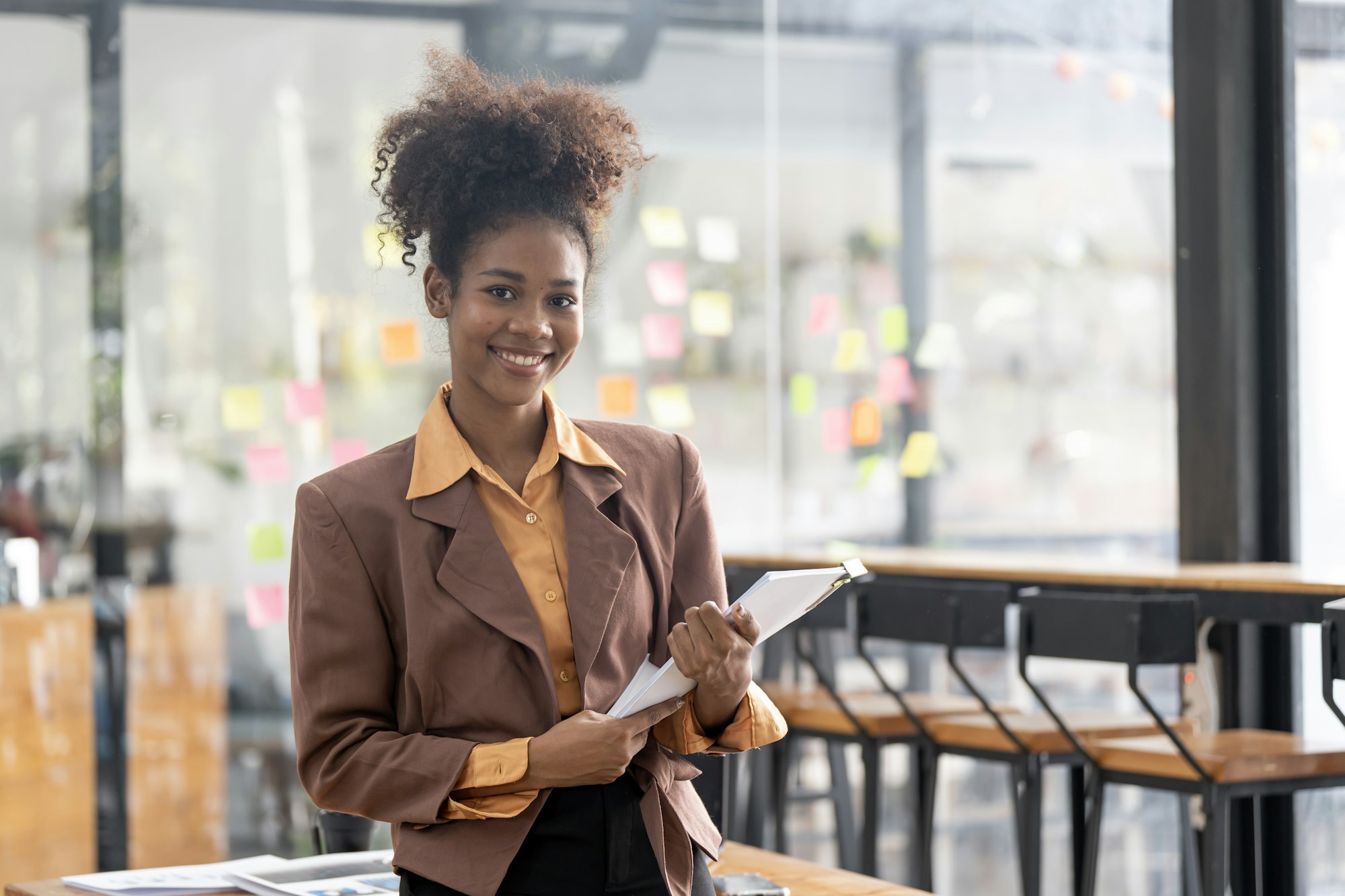 Black business woman using digital tablet in meeting room office workplace.